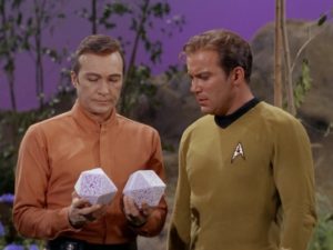 Rojan shows Kirk the pumice-stone d20s that were once two members of his crew.