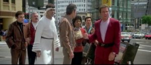 The crew standing in the middle of 1980s San Francisco. Left to right: Chekov, Scotty, Spock, Bones, Uhura, Sulu, Kirk.